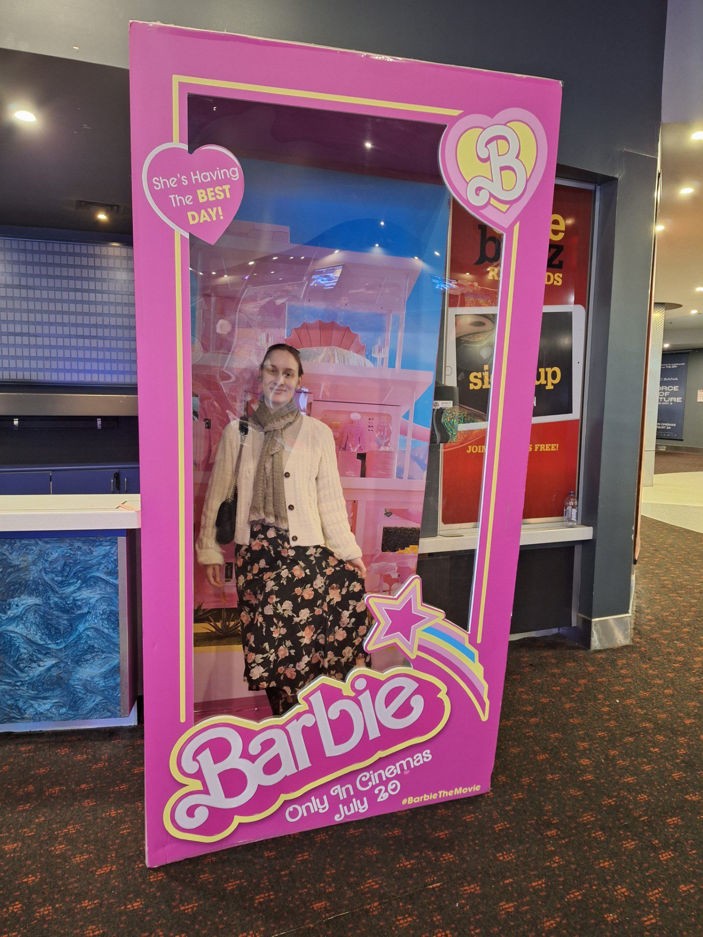A List Socialite Suzanna going to the Barbie movie. Standing in the Barbie cutout frame at the cinema