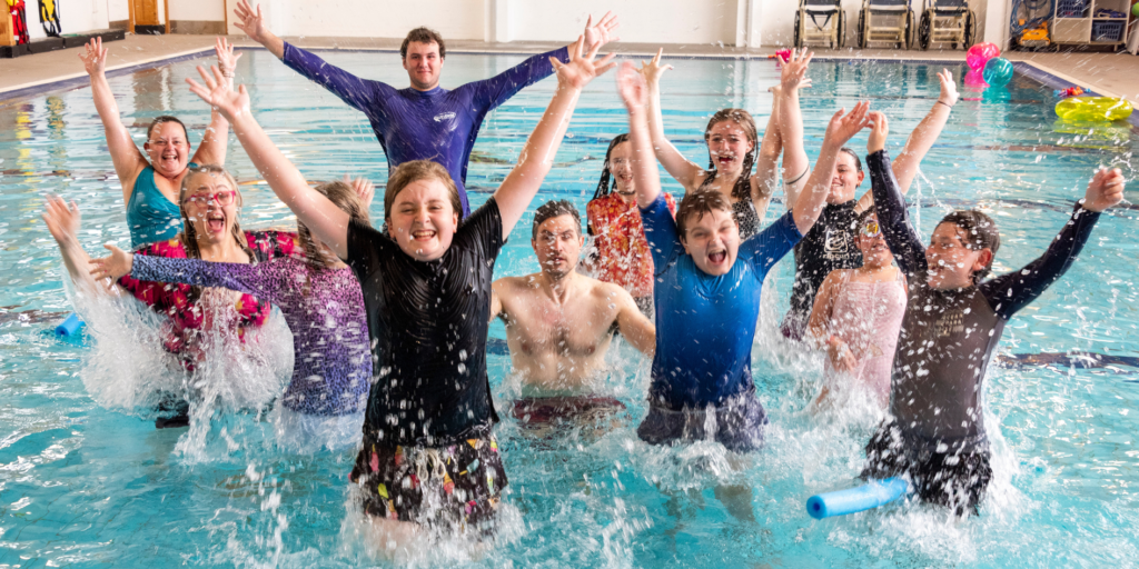 group of people celebrating in the swimming pool